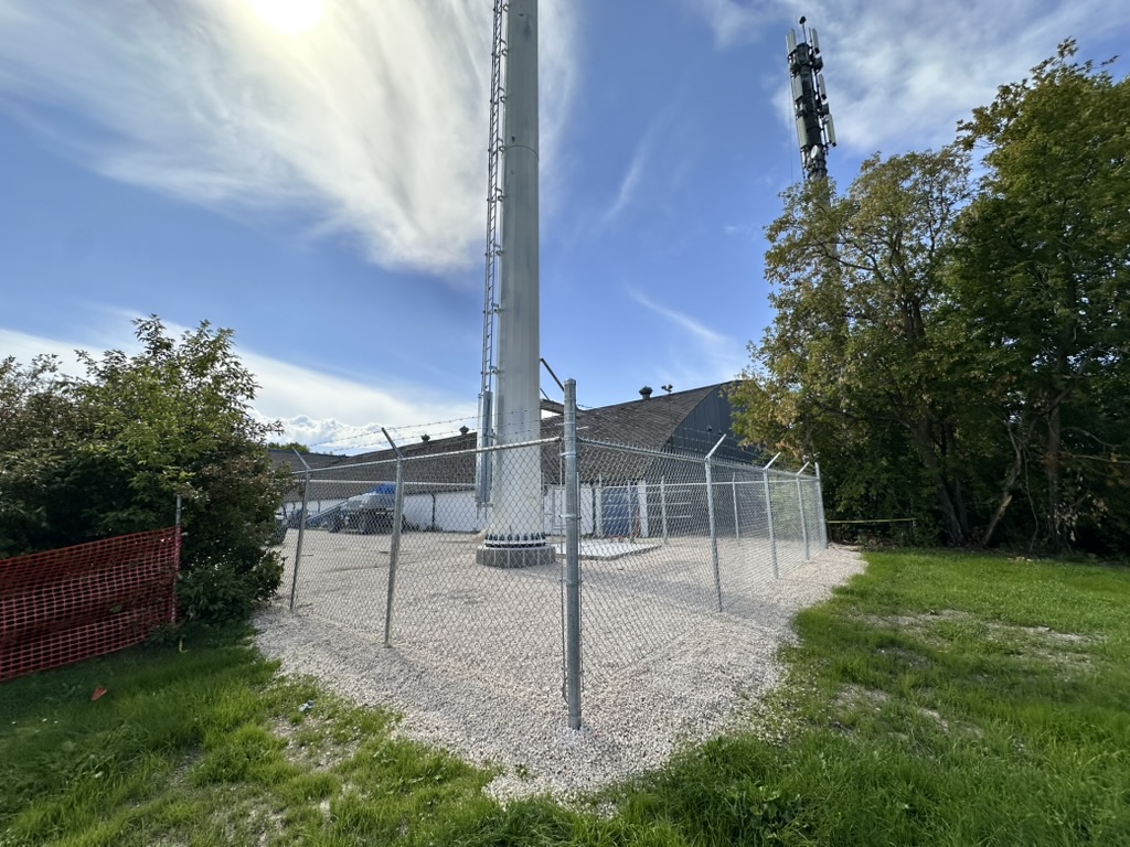 Chain link perimeter fencing around cellular tower