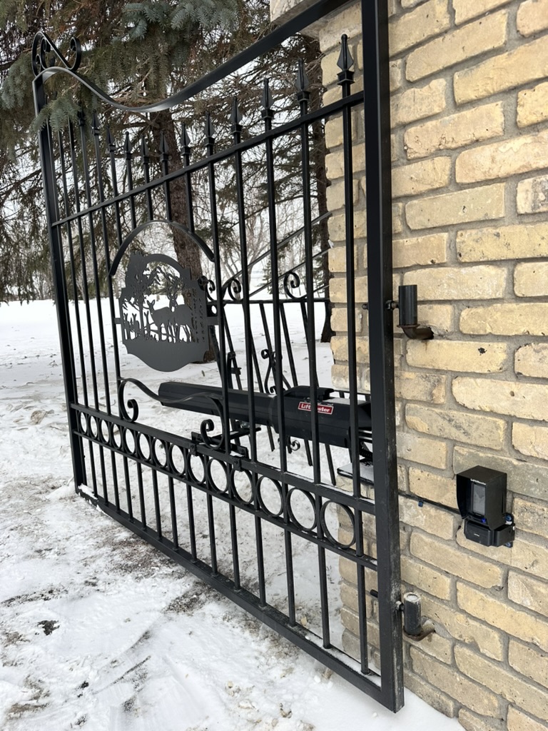 Custom ornamental iron gate with wildlife scrollwork